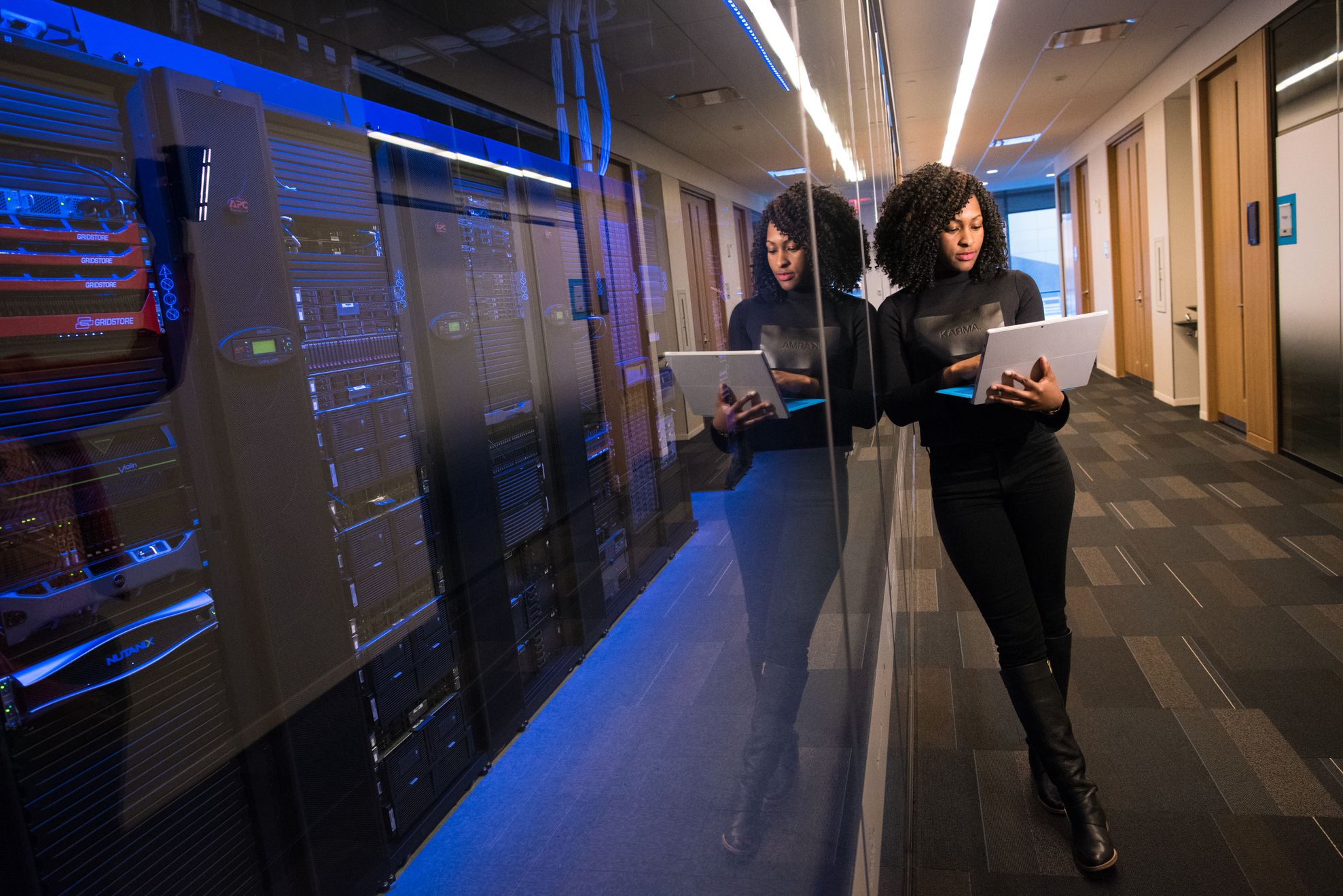 Illustrative photograph of a professional working near server racks